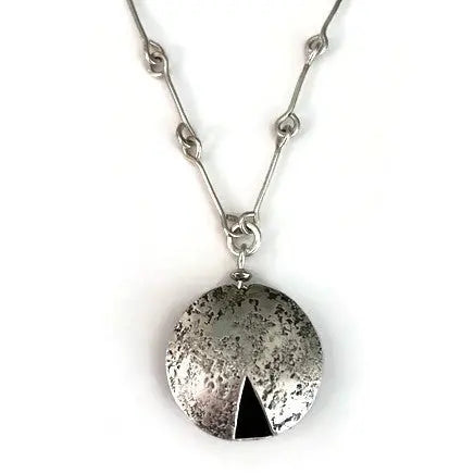 Sterling silver necklace with a round pendant featuring a black triangle