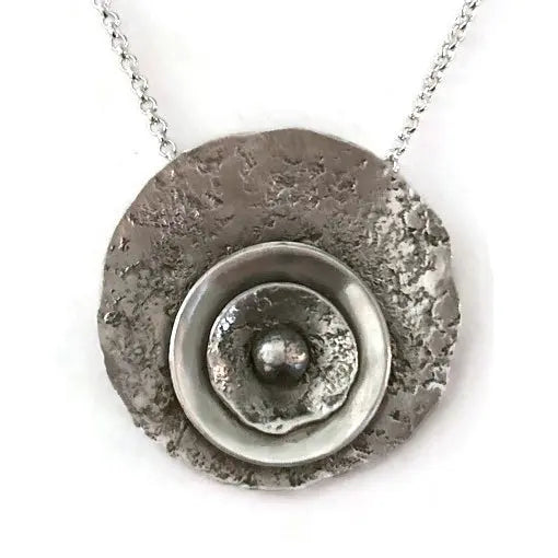Sterling silver necklace with a textured round pendant