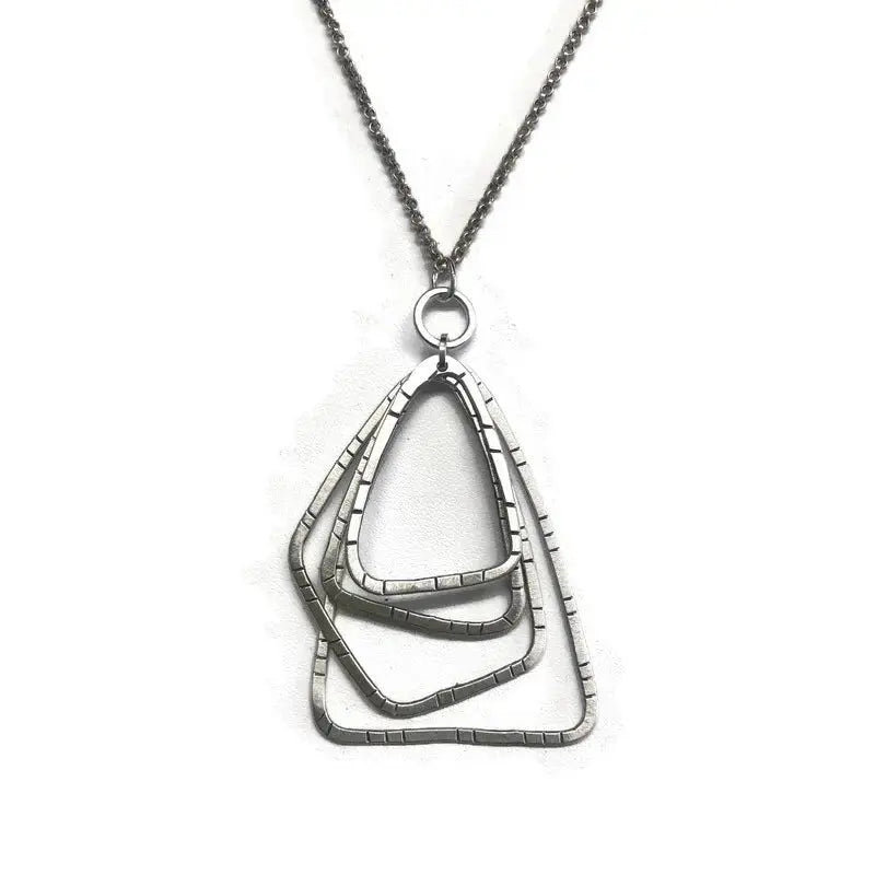 Silver necklace with a geometric pendant on a white background