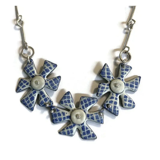 Pair of blue and silver flower-shaped earrings on a white background