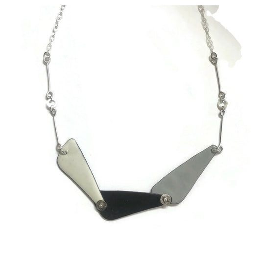 Necklace with geometric pendant on a white background