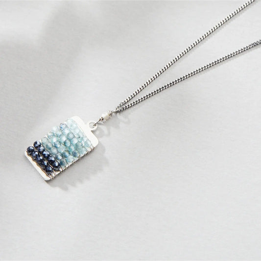 Necklace with a rectangular pendant featuring blue and silver stones 