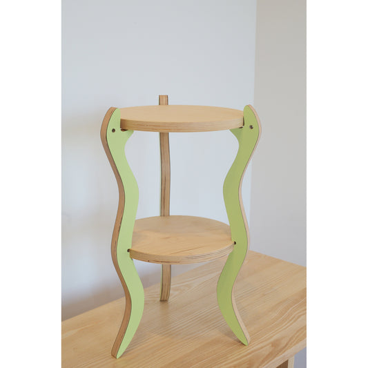 Wooden table with green snake legs on a plain background