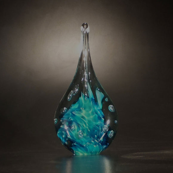 The Glass Forge Twisted Flame Paperweight Shown In Green And Blue Artistic Functional Artisan Handblown Art Glass Paperweights