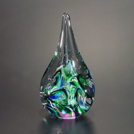 The Glass Forge Twisted Flame Paperweight Shown In Purple Turquoise And Teal Artistic Functional Artisan Handblown Art Glass Paperweights