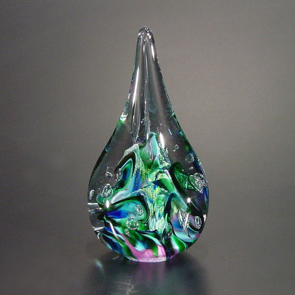 The Glass Forge Twisted Flame Paperweight Shown In Purple Turquoise And Teal Artistic Functional Artisan Handblown Art Glass Paperweights